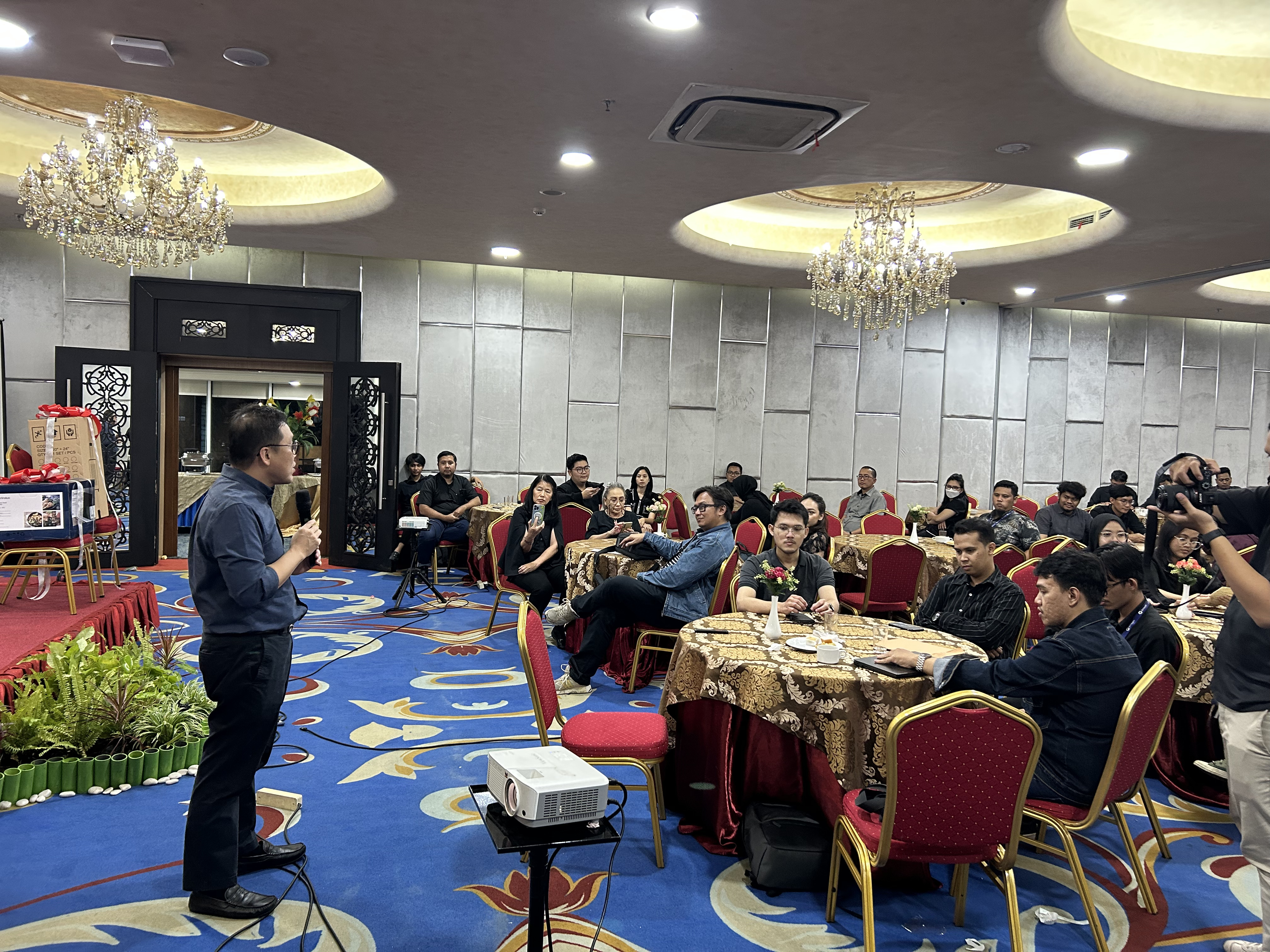 Woman speaking into mic at computer